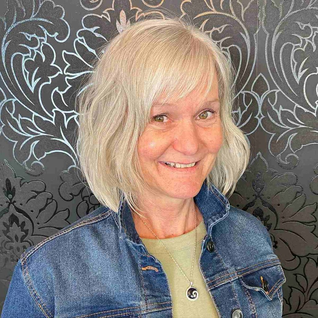 stylish-blonde-layered-bob-with-wispy-bangs-for-60-year-olds